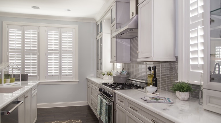 White shutters in Honolulu kitchen with marble counter.